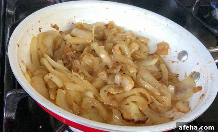 Sliced onions caramelized with beer in white bowl