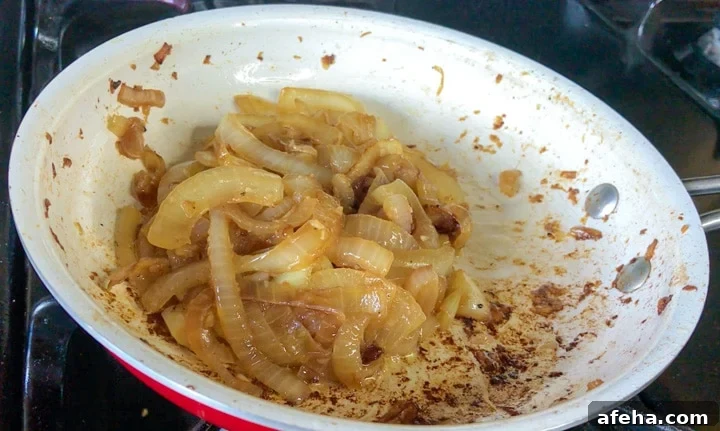 Sliced onions caramelized with beer in white bowl