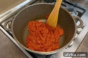 Spicy Satsebeli: Authentic Georgian Tomato Sauce Recipe 8 Adding the tomato paste