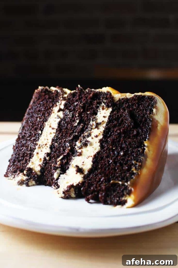 Slice of caramel chocolate cake on a plate with coconut caramel frosting and caramel drizzle 