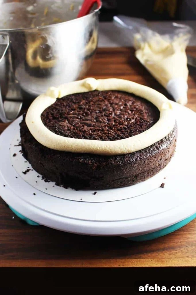 Chocolate cake layer with piped frosting dam - how-to for frosting a caramel chocolate cake 