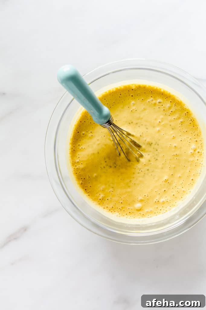 Creamy Mango Chia Pudding Recipe for Tropical Breakfast or Dessert 5 A clear mixing bowl with blended mangos, cashew milk and chia seeds in it