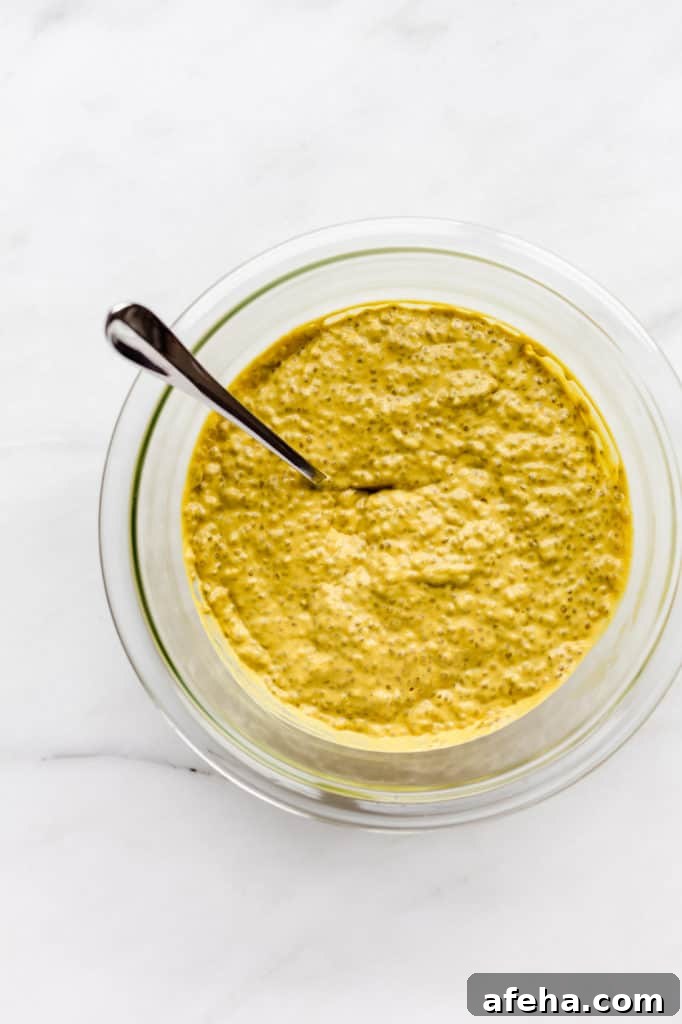 Creamy Mango Chia Pudding Recipe for Tropical Breakfast or Dessert 6 A clear mixing bowl filled with mango chia pudding
