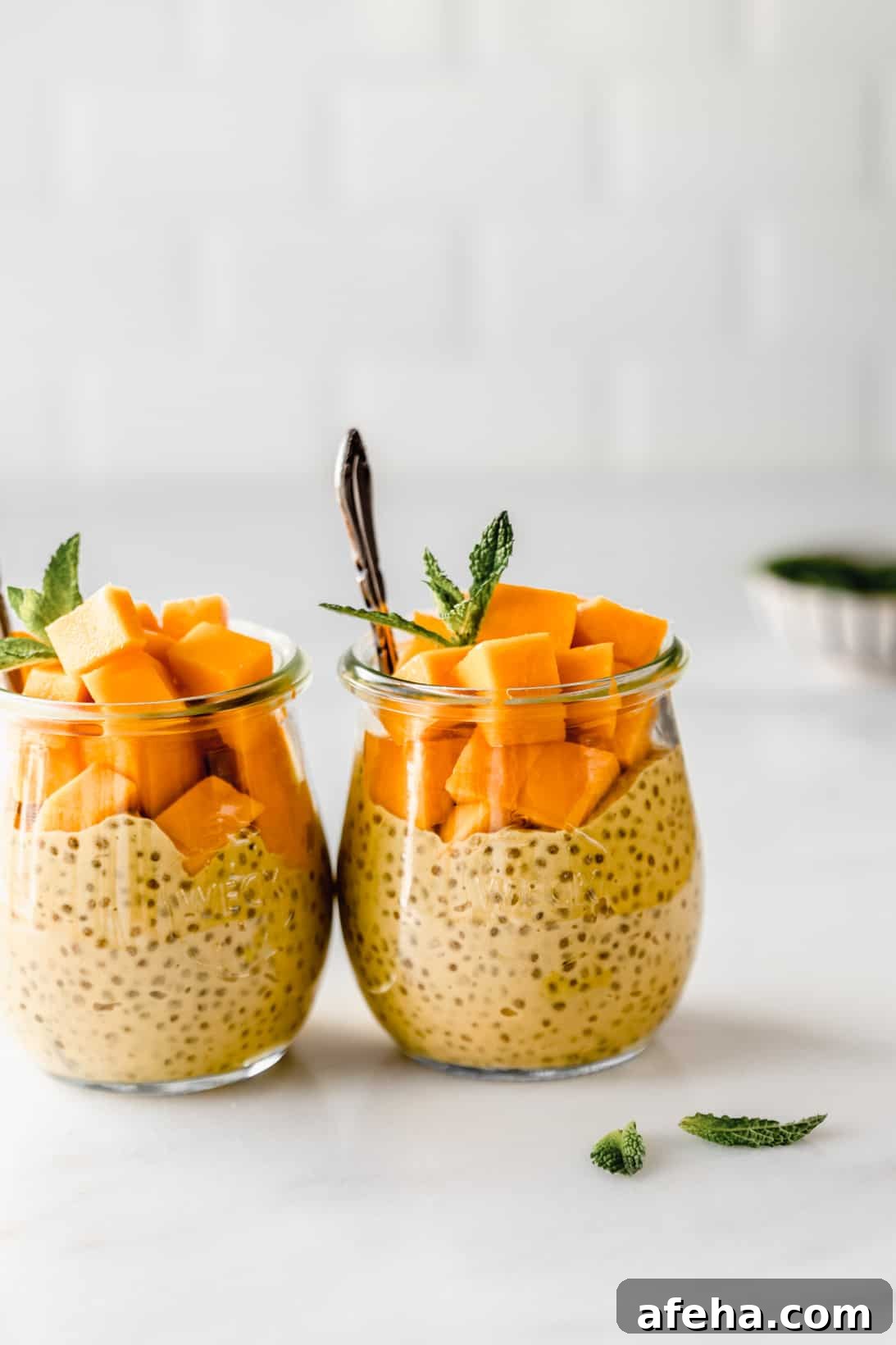 Creamy Mango Chia Pudding Recipe for Tropical Breakfast or Dessert 8 Two small jars of mango chia pudding topped with cubes of mango