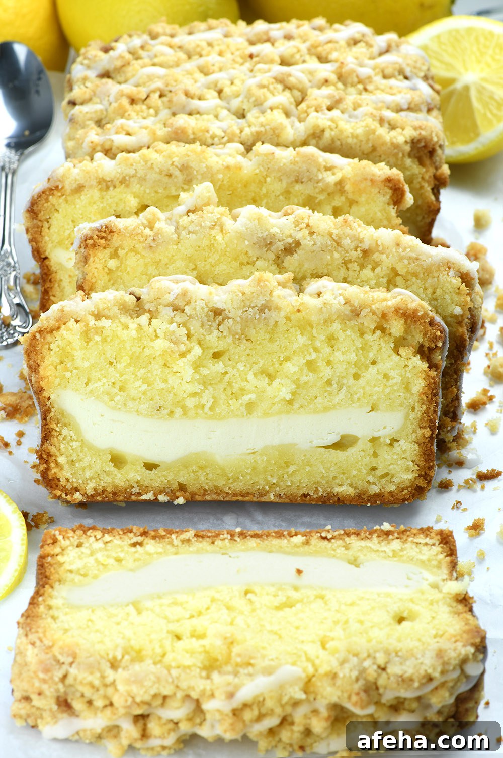Lemon Cream Cheese Pound Cake Recipe with Luscious Glaze 2 Lemon Pound Cake with cream cheese filling couple of slices on white paper.
