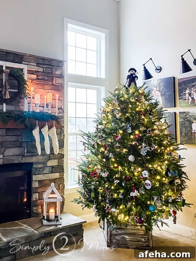 decorated christmas tree in front of window next to fireplace