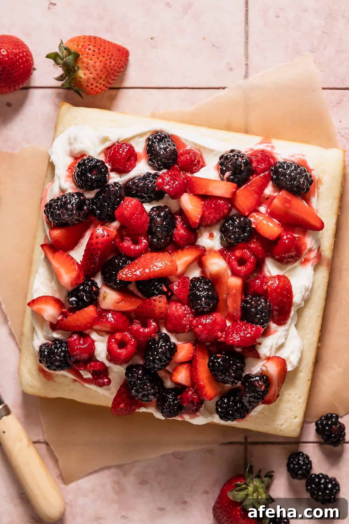lemon berry mascarpone cake with fresh berries on top.
