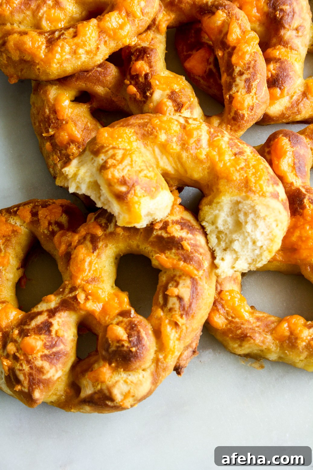 Cheesy Garlic Soft Pretzels Recipe for Melty, Savory Bites 3 Soft and chewy homemade pretzels with orange cheddar and garlic