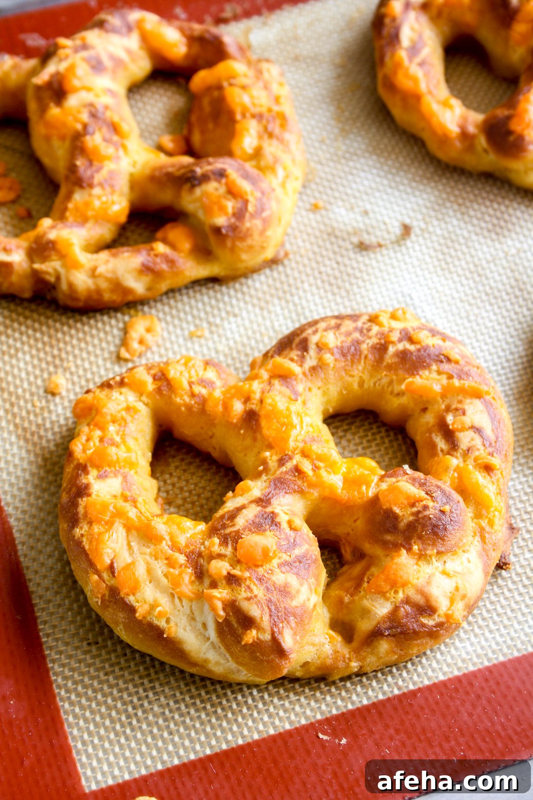 Cheesy Garlic Soft Pretzels Recipe for Melty, Savory Bites 5 Soft and chewy homemade pretzels with orange cheddar and garlic