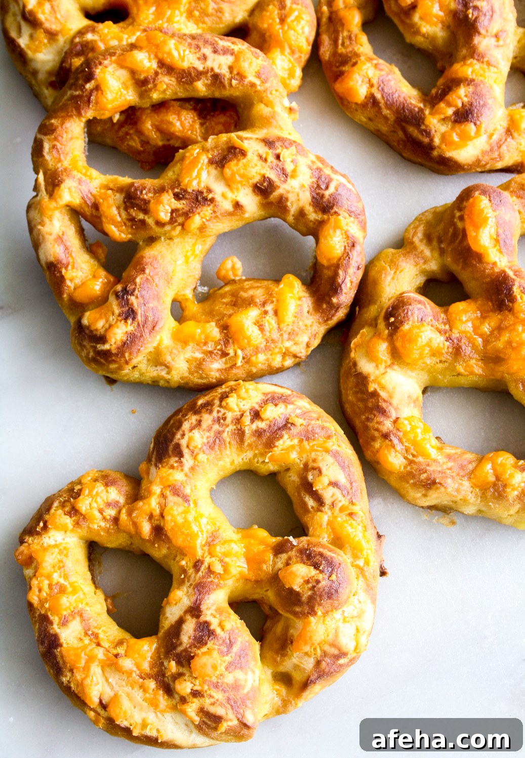 Cheesy Garlic Soft Pretzels Recipe for Melty, Savory Bites 7 Soft and chewy homemade pretzels with orange cheddar and garlic