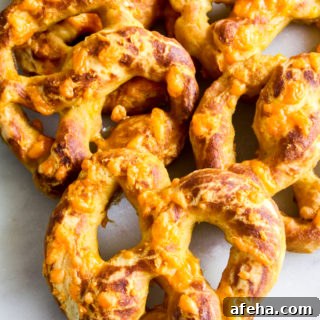 Cheesy Garlic Soft Pretzels Recipe for Melty, Savory Bites 8 Soft and chewy homemade pretzels with orange cheddar and garlic