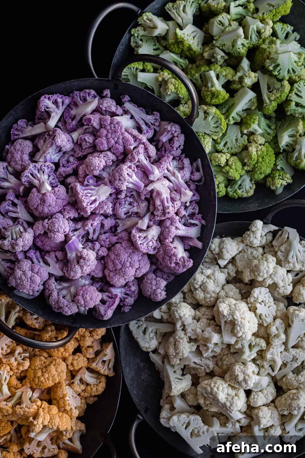 Purple Cauliflower Varieties: Flavor, Nutrition & Cooking Tips 6 purple, green, orange and white cauliflower florets, separated by color, in silver bowls