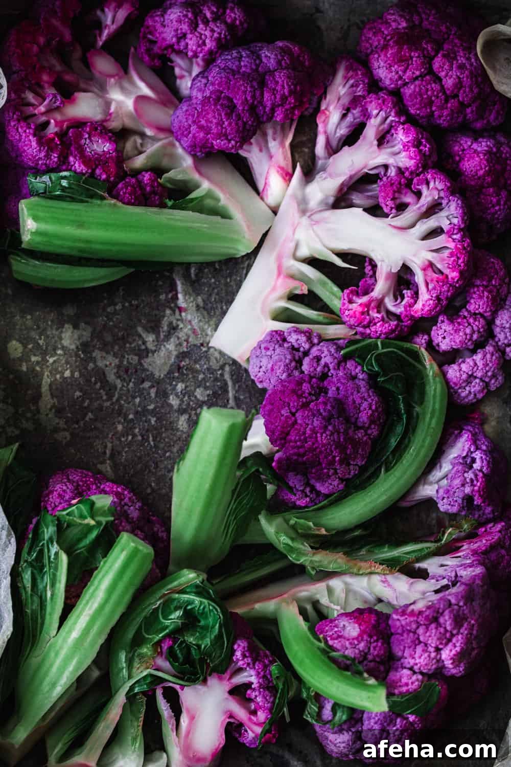 Purple Cauliflower Varieties: Flavor, Nutrition & Cooking Tips 10 blanched purple cauliflower on a baking sheet; overhead