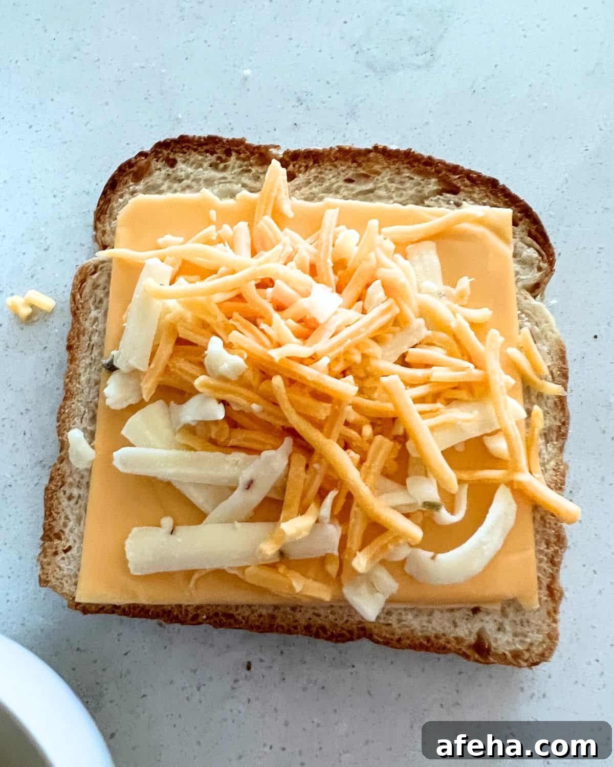 Crispy Air Fryer Grilled Cheese with Mayo Spread 4 Cheese on top of bread for air fryer grilled cheese.