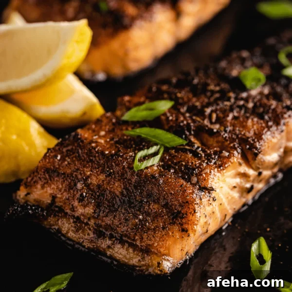 Grilled blackened salmon filet on a serving platter.