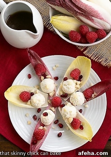 Overhead view of a star of Endive Cups with Blue Cheese, Raspberries and Macadamia Nuts.