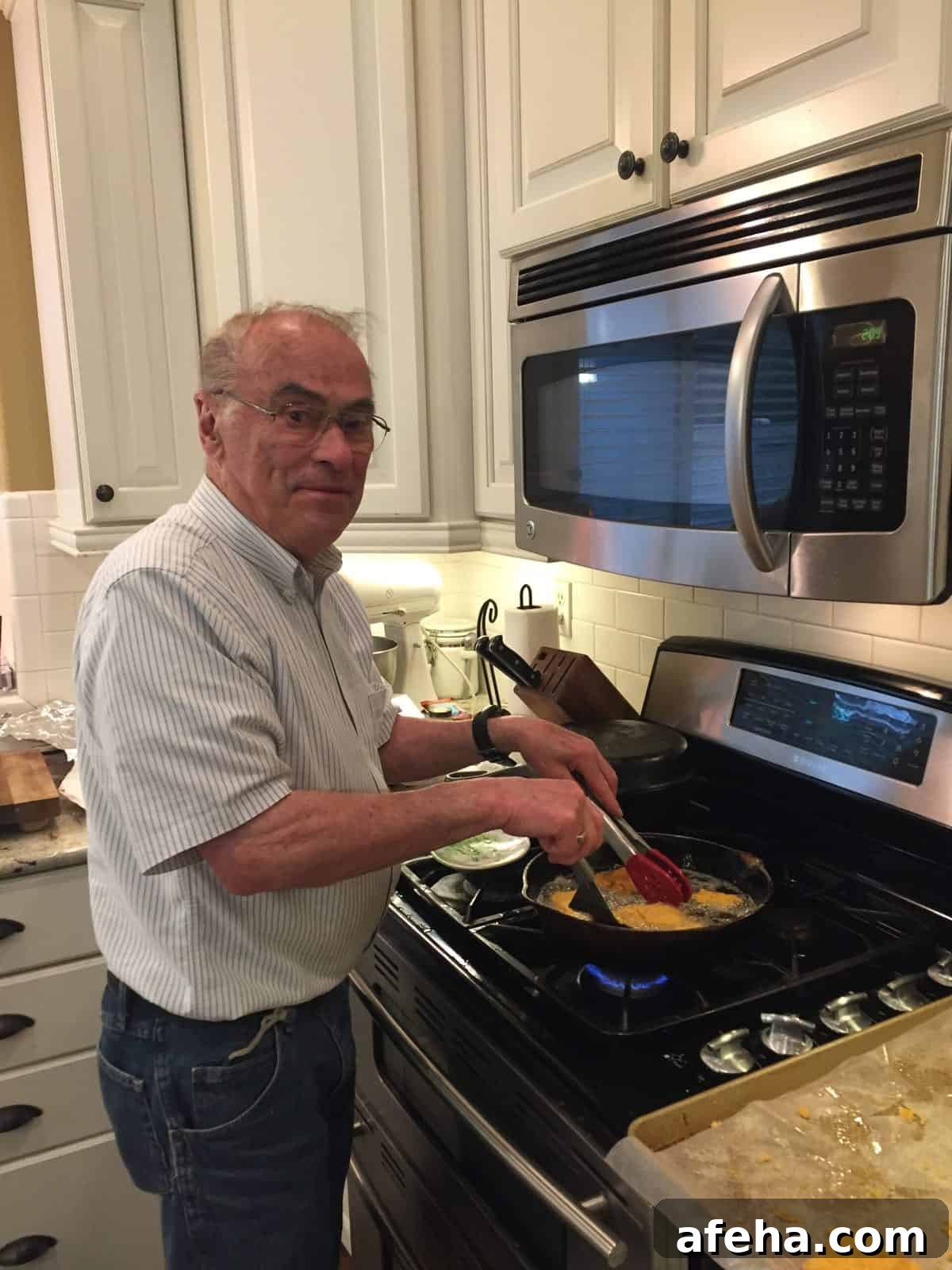 Melinda's dad frying cod in a cast iron skillet on the stove.