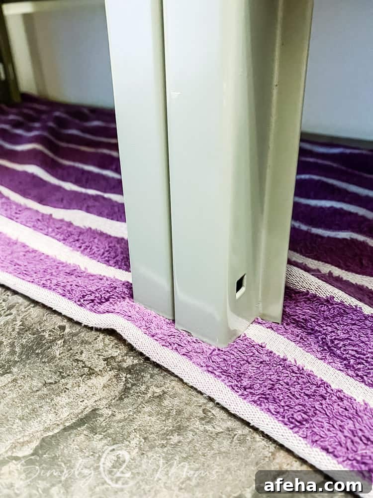 close up of middle locker legs on top of towel on floor