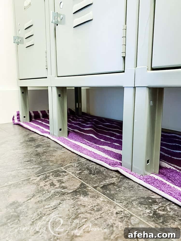 close up of three front locker legs sitting under towel on floor