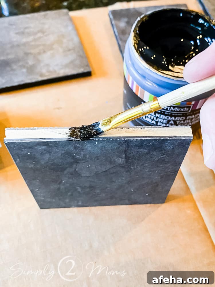 hand holding small paint brush painting cut open edge of diy floor protectors