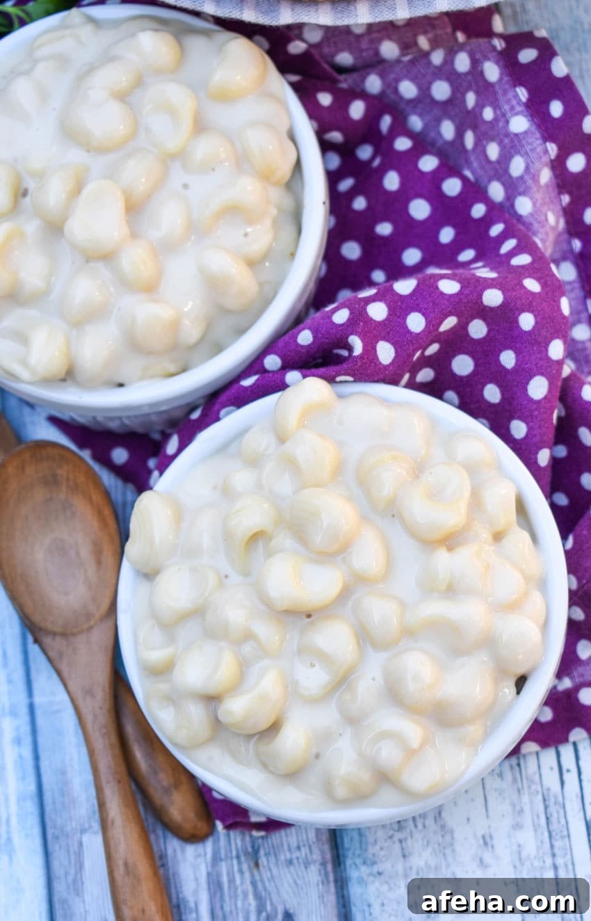 Panera Mac and Cheese Copycat Recipe: Creamy, Restaurant-Style 3 copycat panera mac and cheese recipe shown in two white ramekins with crusty rolls on the side