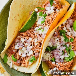 Authentic Chicken Tinga Recipe: Smoky Mexican Shredded Chicken 11 Chicken tinga tacos on a plate.