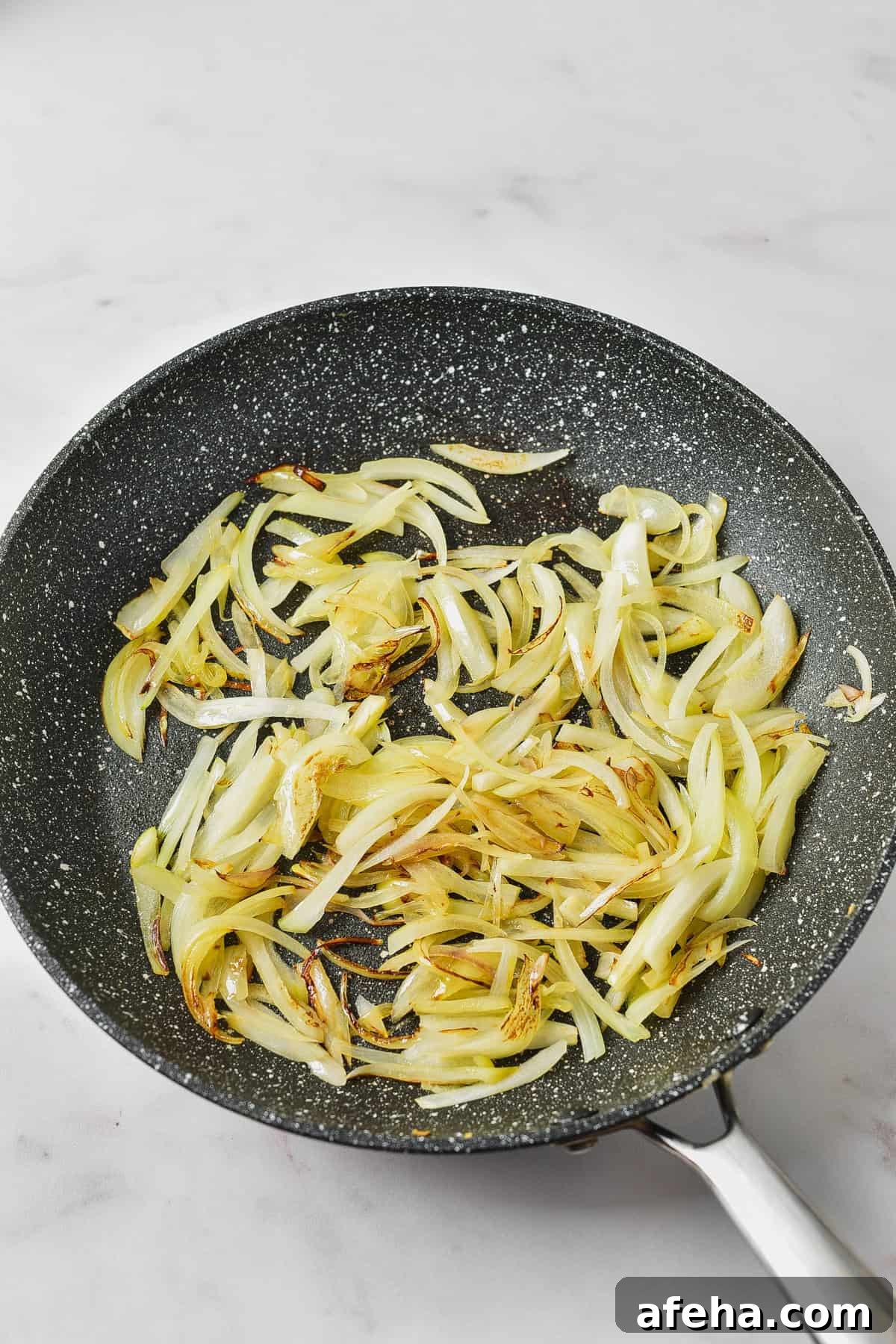 Authentic Chicken Tinga Recipe: Smoky Mexican Shredded Chicken 4 Cooking onions in a skillet.