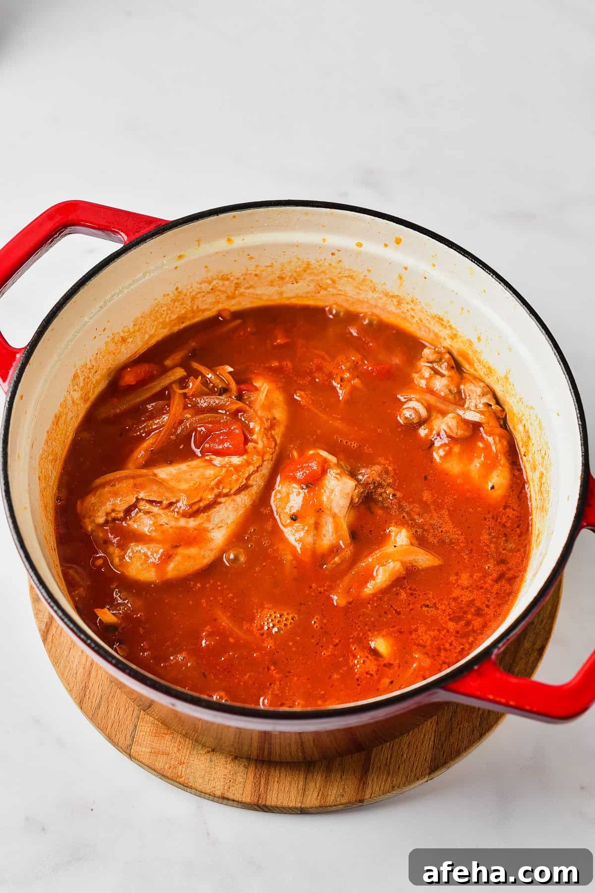 Authentic Chicken Tinga Recipe: Smoky Mexican Shredded Chicken 6 Cooking chicken in tanga suace.
