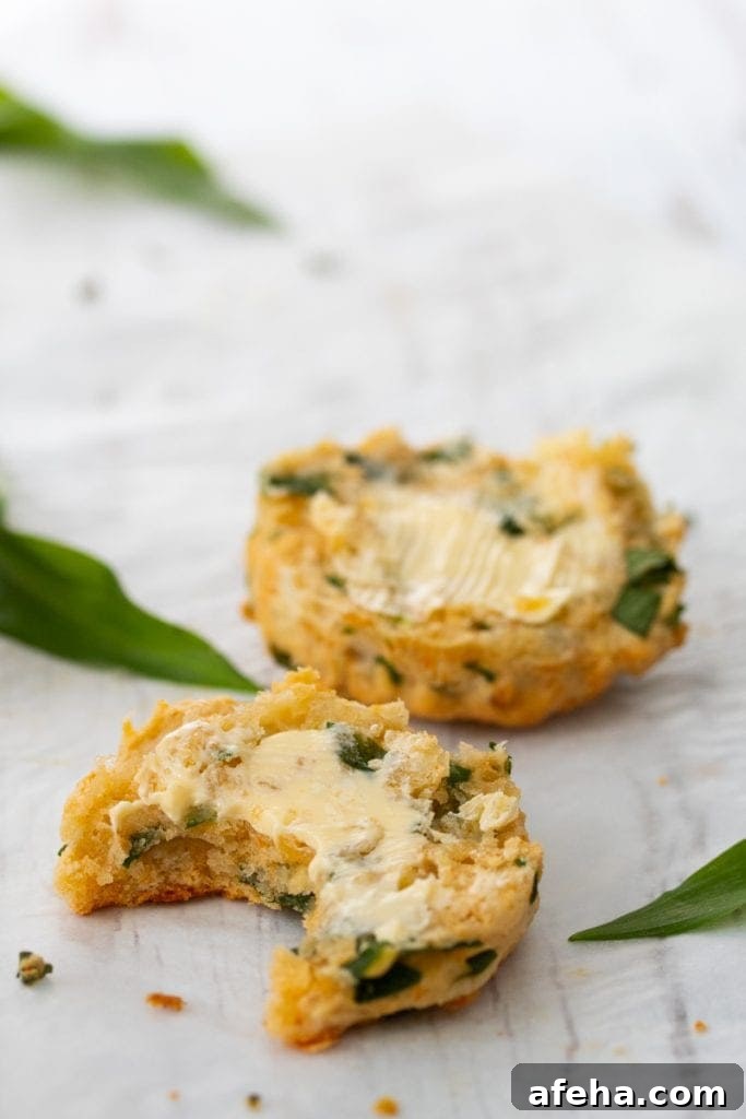 Cheesy wild garlic scone cut in half with butter on the top
