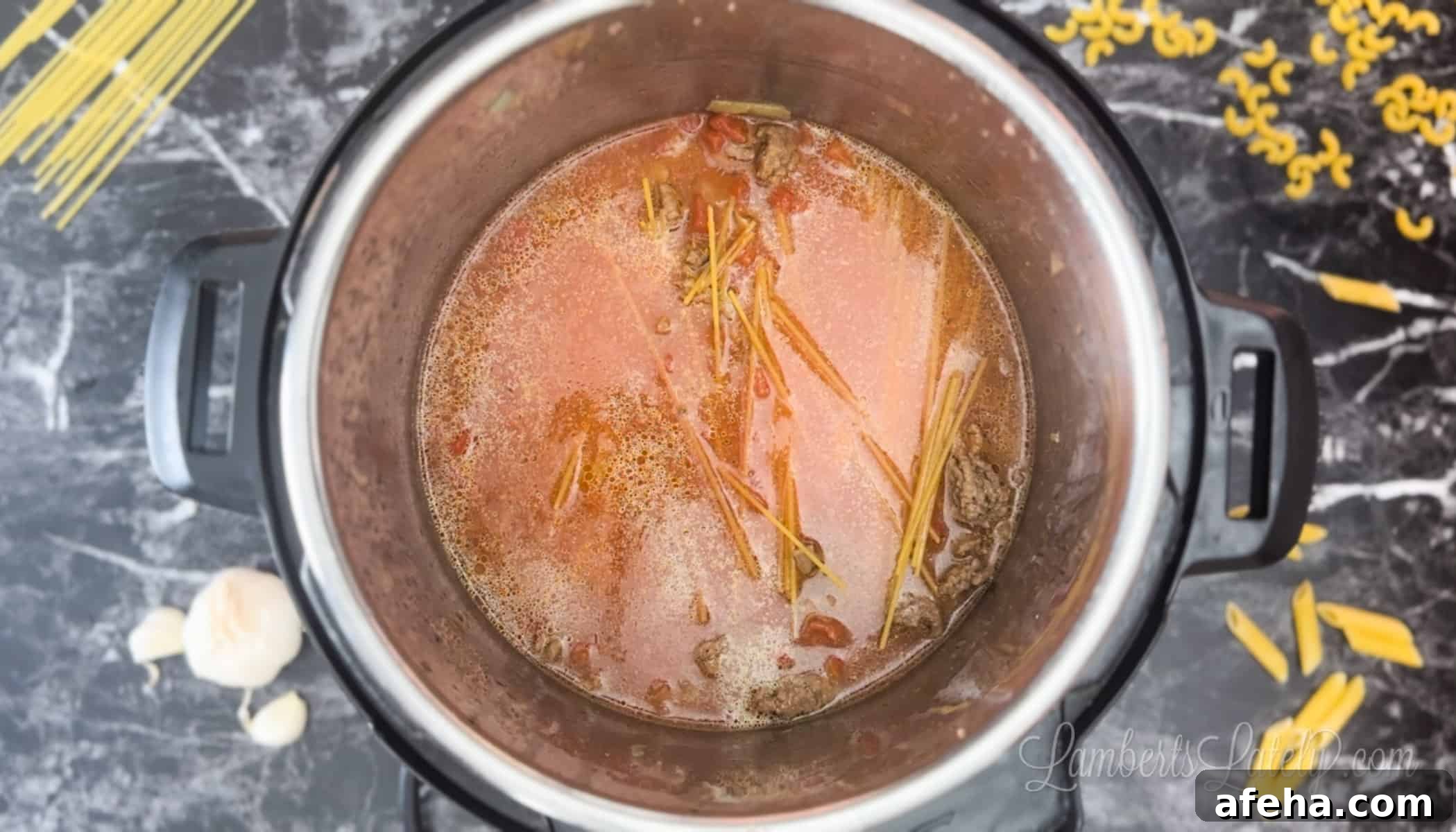 pasta noodles in tomatoes and water in an instant pot.