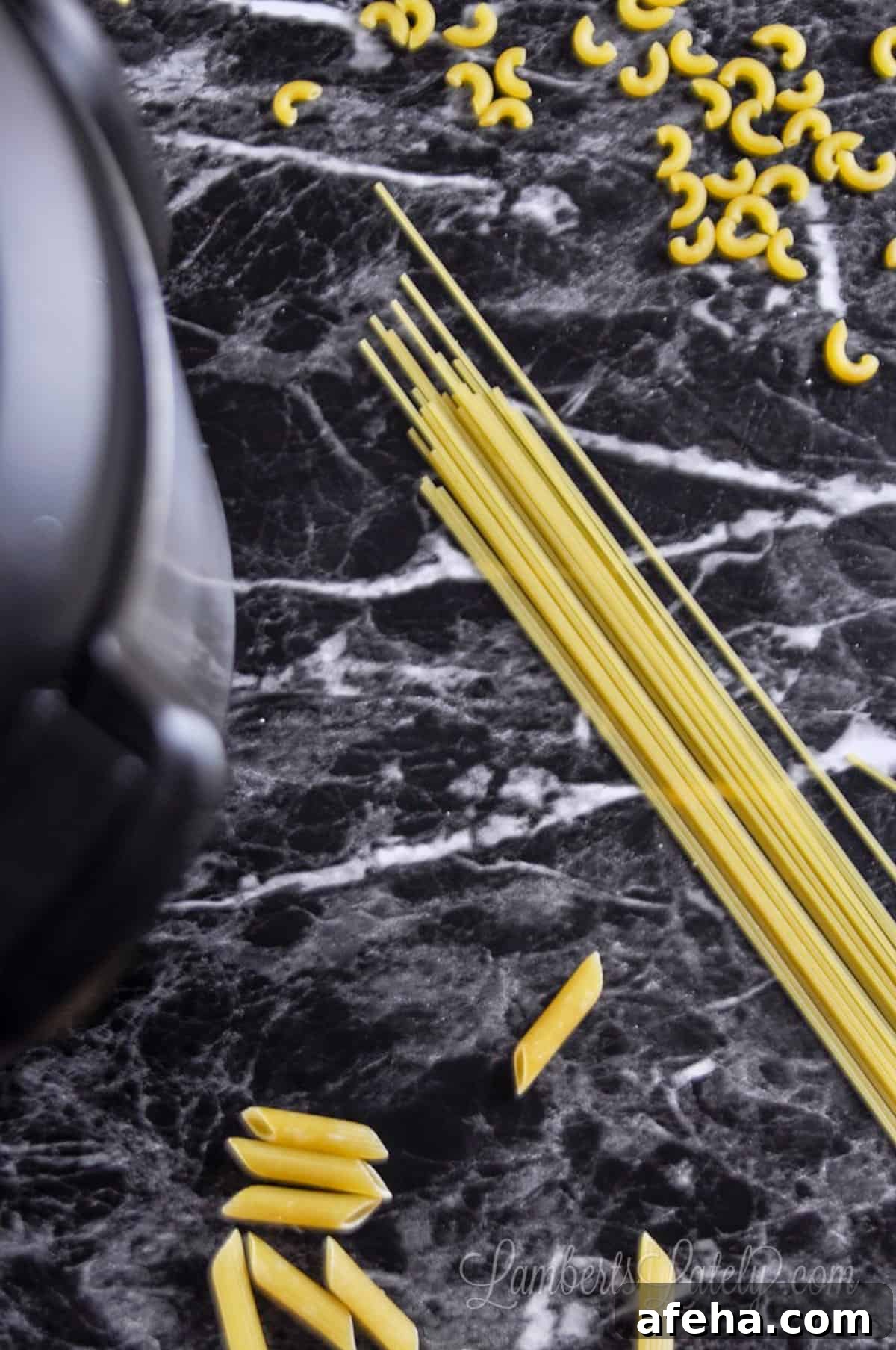 pasta on a dark counter, next to an instant pot.