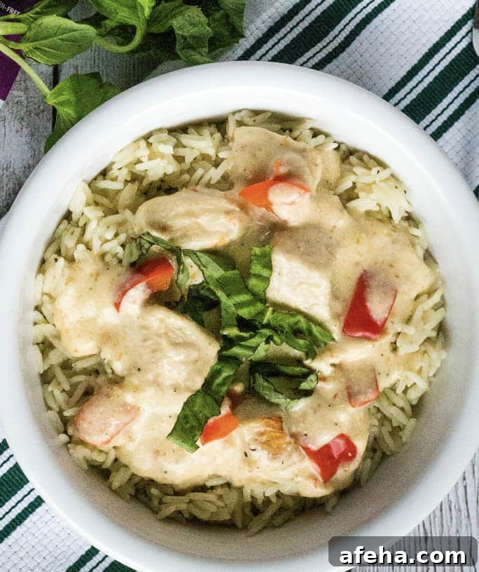 white bowl filled with rice and creamy Italian chicken cooked in the Instant Pot