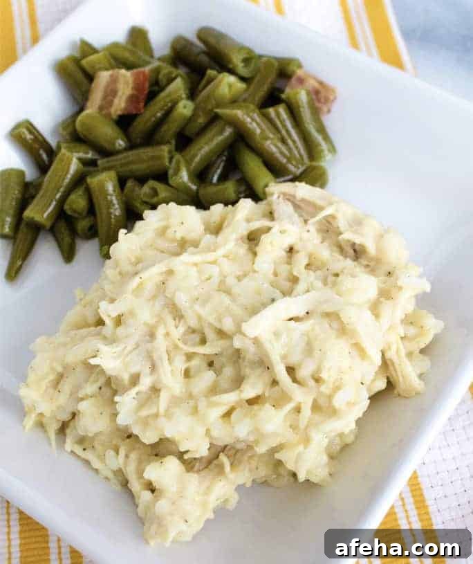 white plate with Instant Pot chicken and rice casserole on it, alongside green beans