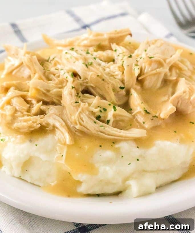 a bed of mashed potatoes covered with instant pot chicken and gravy