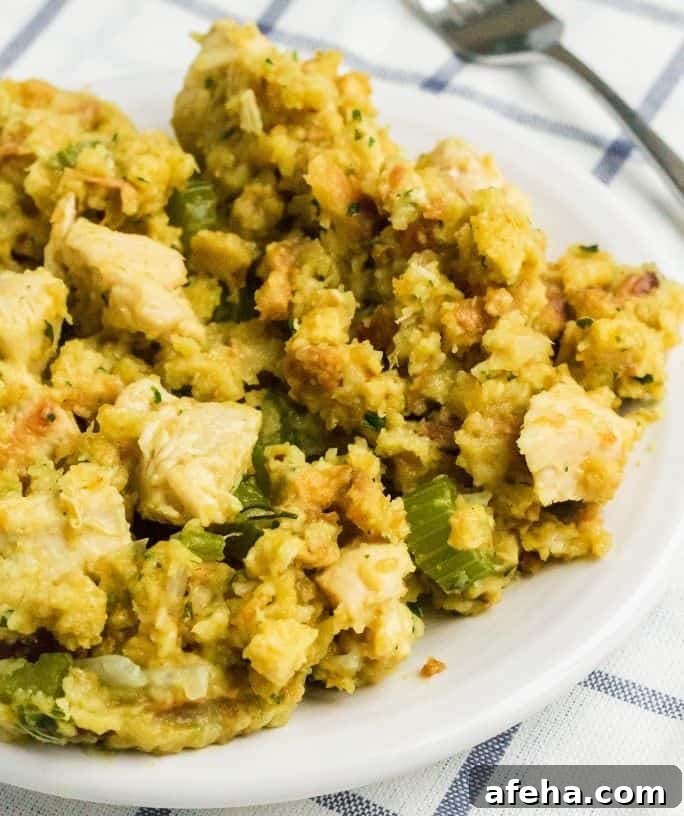 a white plate with a helping of chicken and stuffing cooked in the Instant Pot