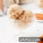 Close up on 3 scoops of ice cream in a glass dessert cup.