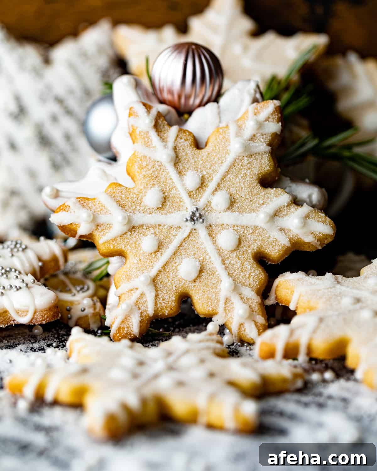 snowflake cookies scattered around on a table.