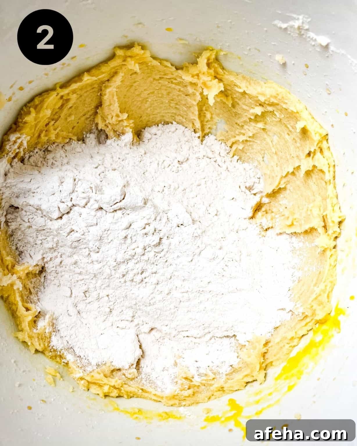 flour added to the wet ingredients in a mixing bowls.