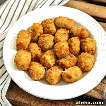 A plate of air fried veggie tots served in a white plate.