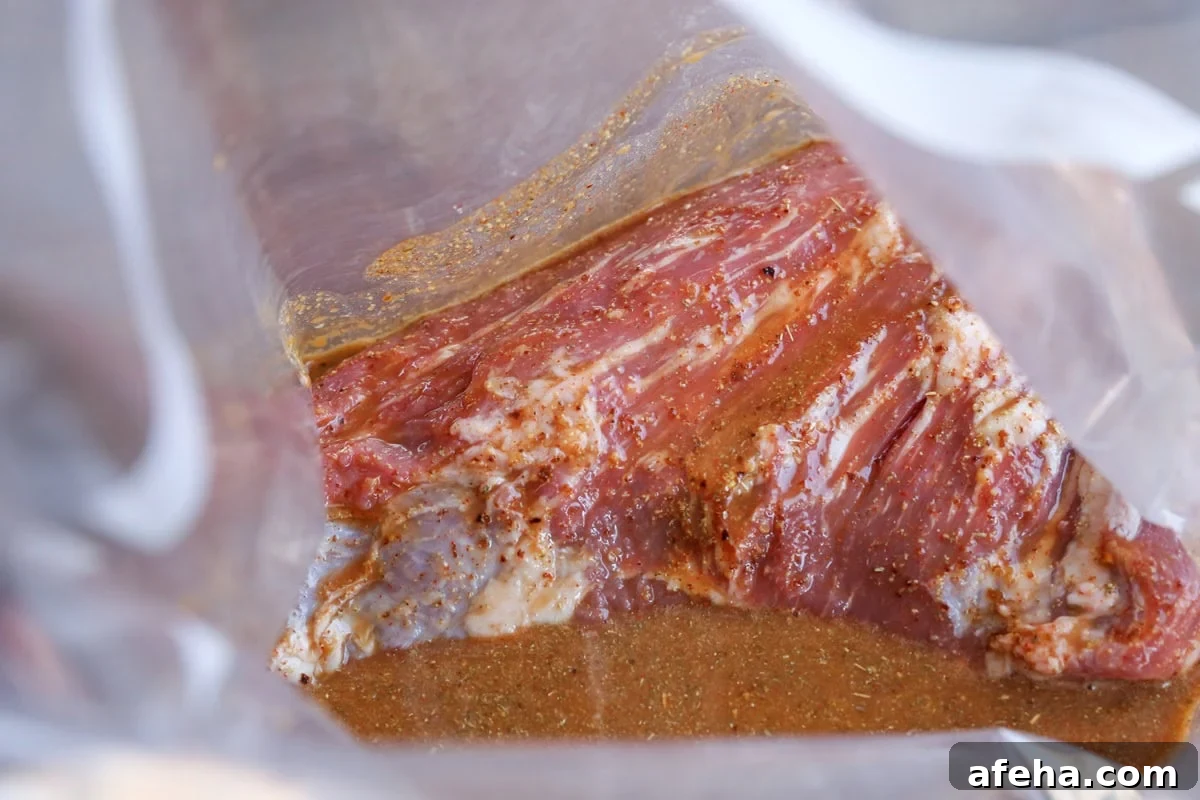 Tri tip marinating in a zip lock bag with marinade.