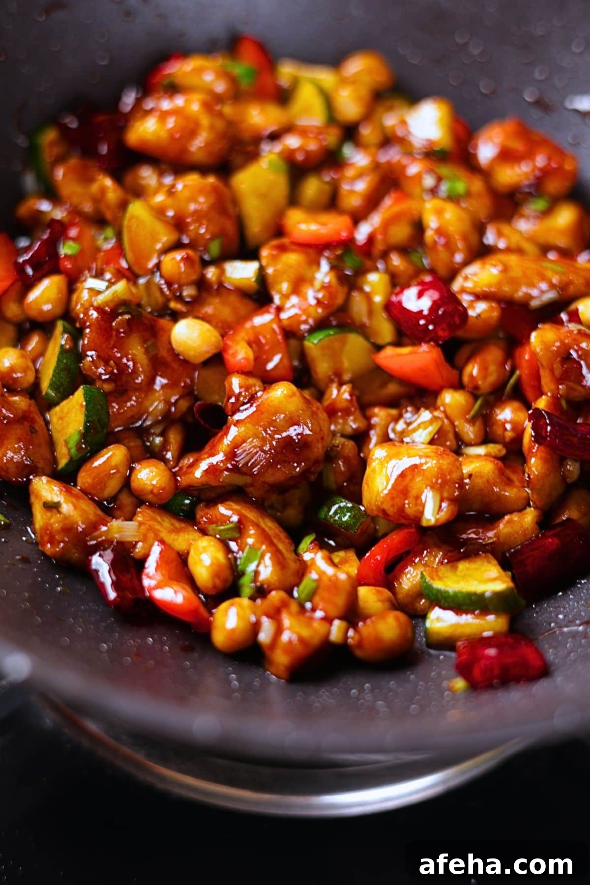 Kung pao chicken quoted in a glossy sauce with peanuts and dried red chilies.