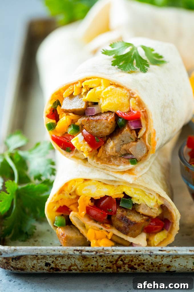 Breakfast Burrito Recipe | Sausage Breakfast Burrito A cross section of a breakfast burrito filled with eggs, sausage, beans and cheese.