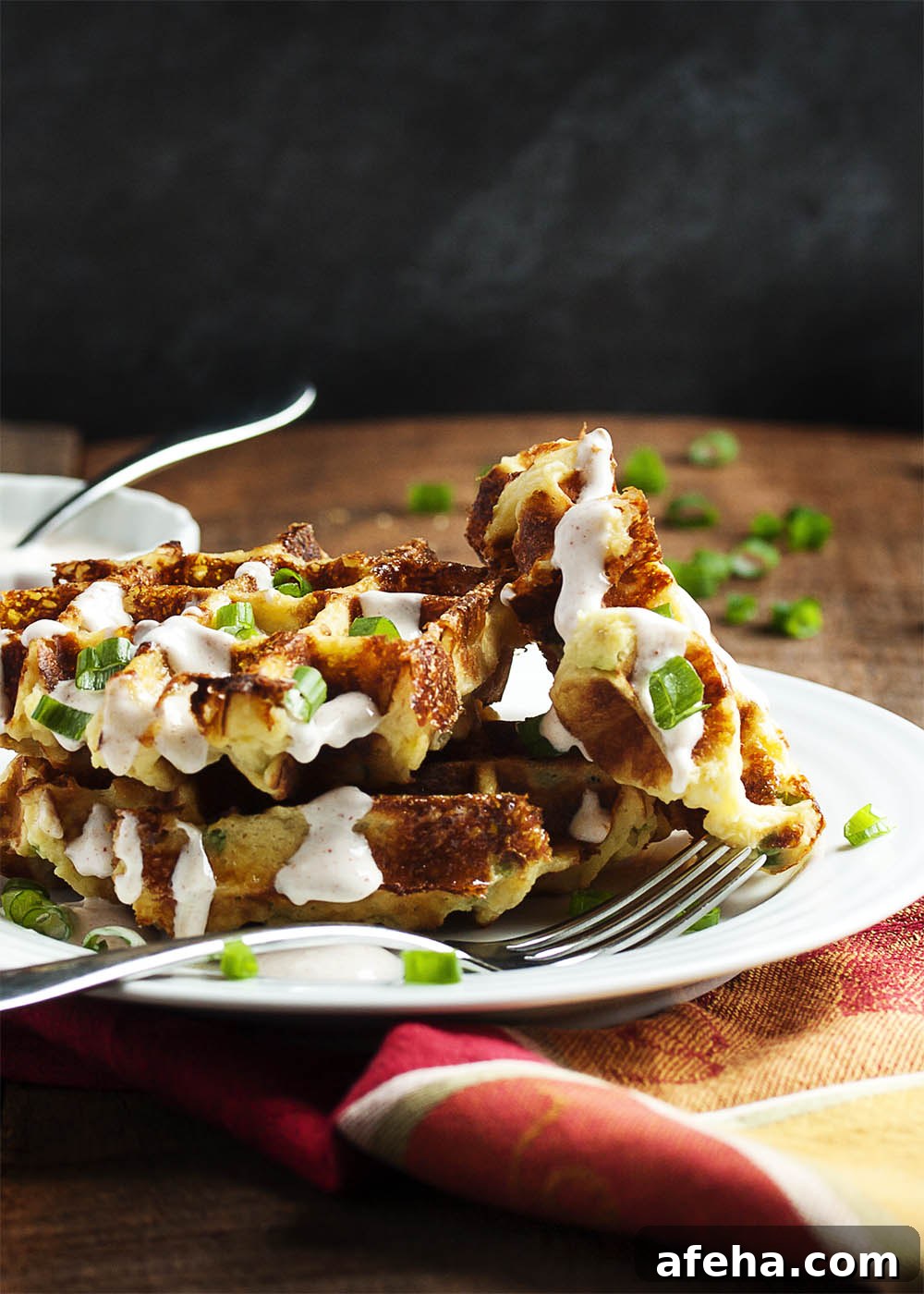 Loaded Mashed Potato Waffles - Mashed Potato Waffles are filled with scallions and cheese and are an awesomely tasty way to enjoy leftover mashed potatoes.