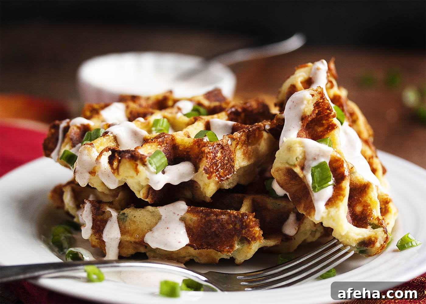 Loaded Mashed Potato Waffles - Mashed Potato Waffles are filled with scallions and cheese and are an awesomely tasty way to enjoy leftover mashed potatoes.