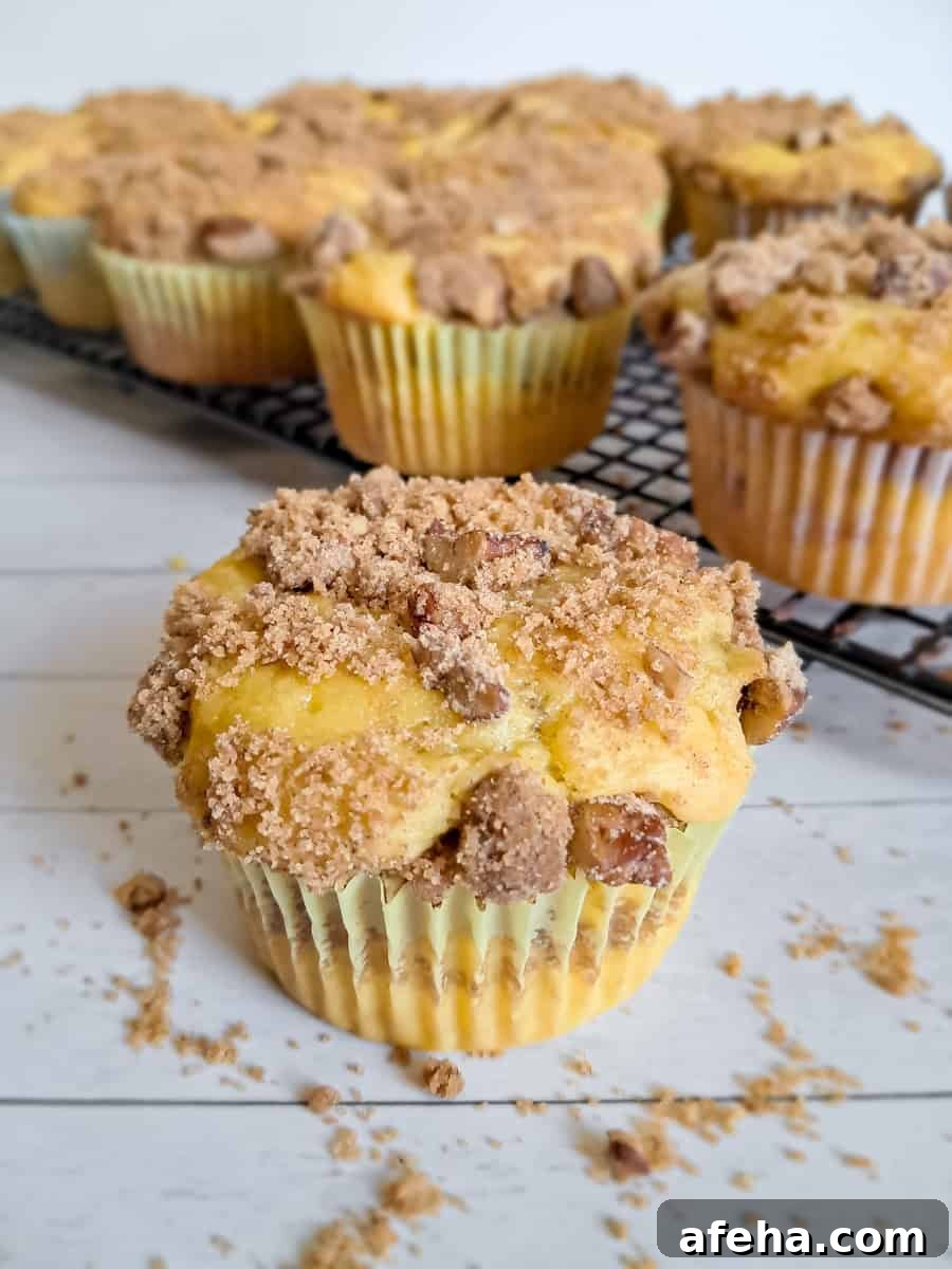 Close-up of an Amish coffee cake muffin and more on a rack in the background.