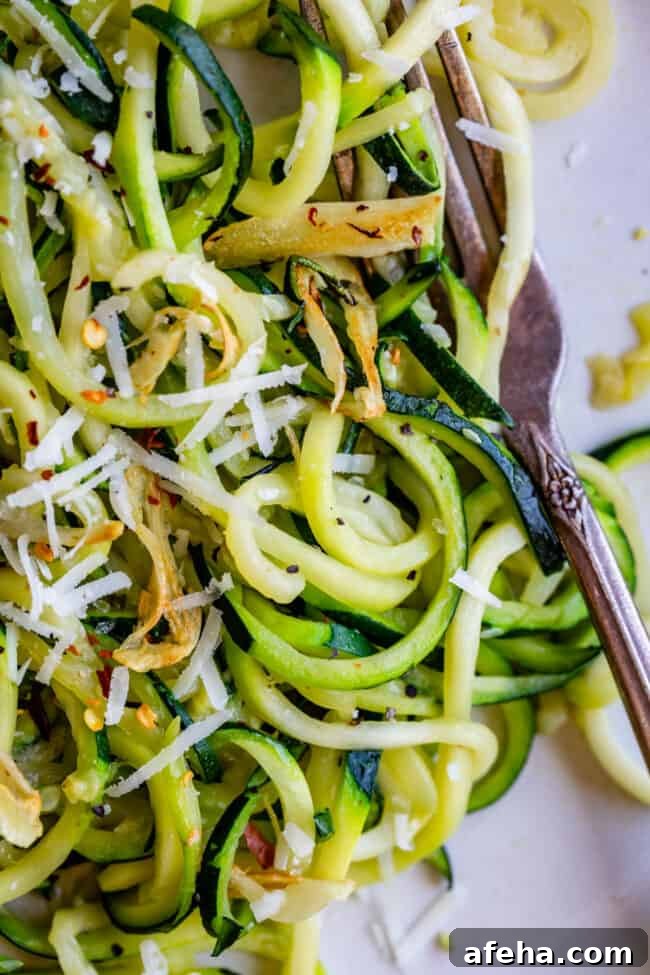 zoodles with red pepper flakes on a fork. 