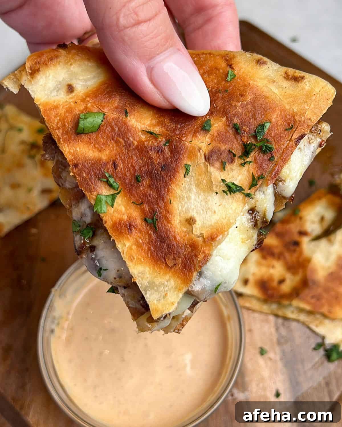 Smoky Chipotle Steak Quesadillas with Creamy Crema 6 steak quesadillas held in hand