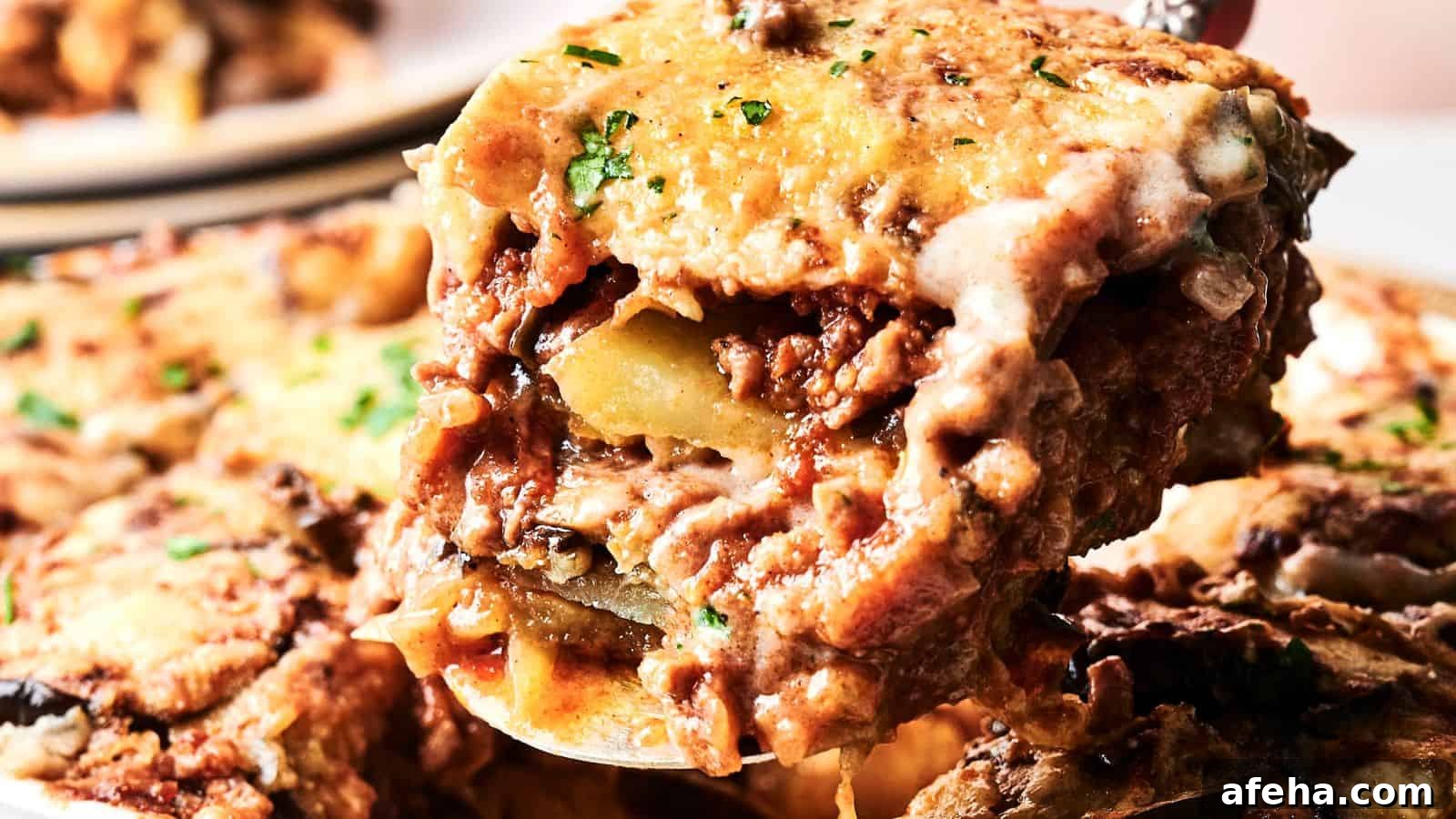 A close-up of a serving of cheesy baked lasagna with visible layers of pasta, meat sauce, and melted cheese.