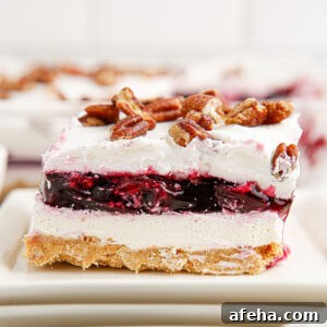 A slice of Blueberry Delight on a white plate.