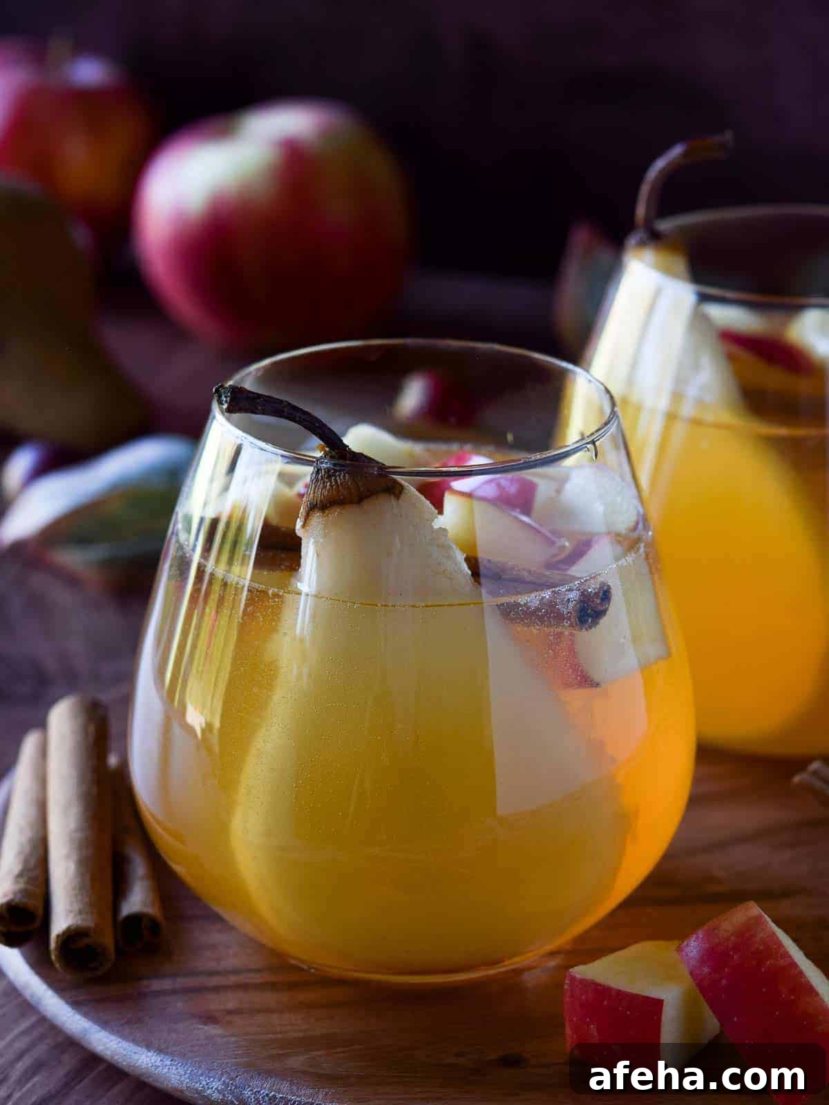Spiced Apple & Pear White Sangria Recipe for Fall Gatherings 2 Close-up of apple and pear sangria in a glass.